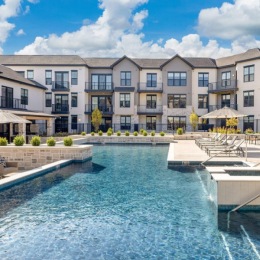 Resort-style swimming pool with lounge seating