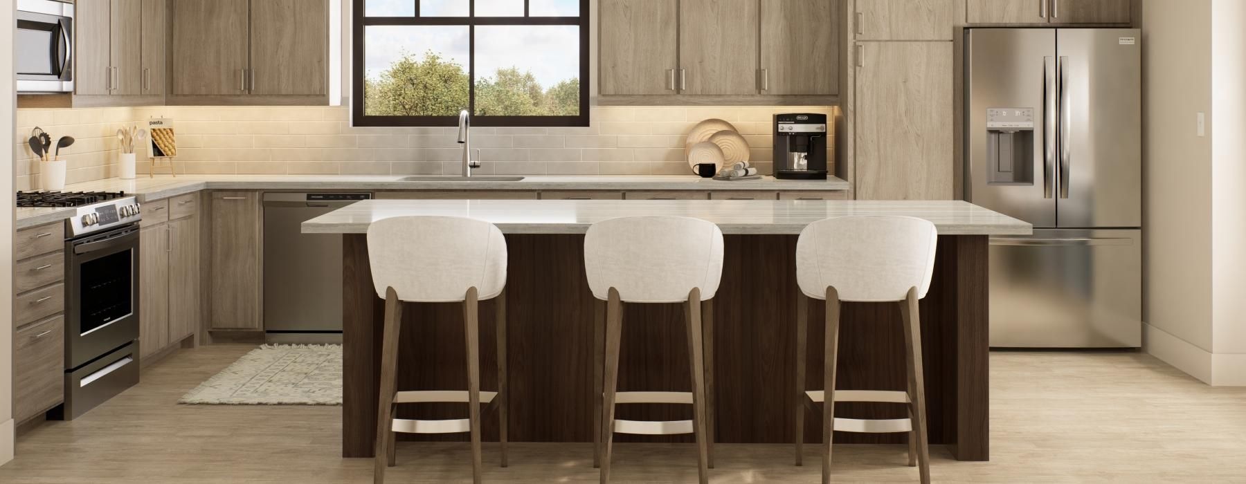 Model kitchen at our 55 and over community in Overland Park, KS, featuring wood grain flooring and counter seating.